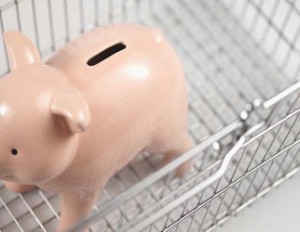 Close-up of piggy bank in shopping trolley