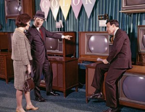 1960s Couple Man Woman Talking To Salesman In Color Television Set Sales Department