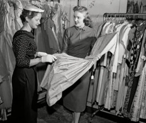 Woman choosing dress in shop