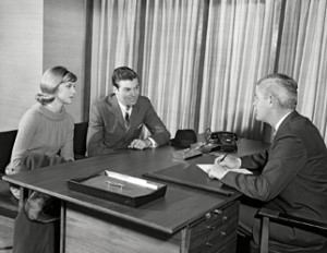 Young couple at desk meeting with businessman