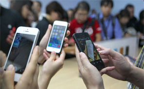 Journalists take pictures of a new Apple iPhone handset with their cellphones during an Apple press conference in Beijing on September 11, 2013. (Photo: AFP/Getty)