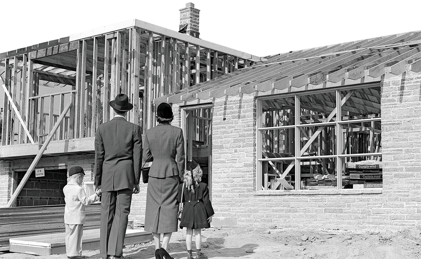 1950s Family Looking At New Home Under Construction