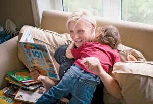 (Stacey Grewal reads with her youngest son Dhillon, 2, who is sick with a high temperature, at their home in Brampton, Ont (Photograph by Darren Calabrese)