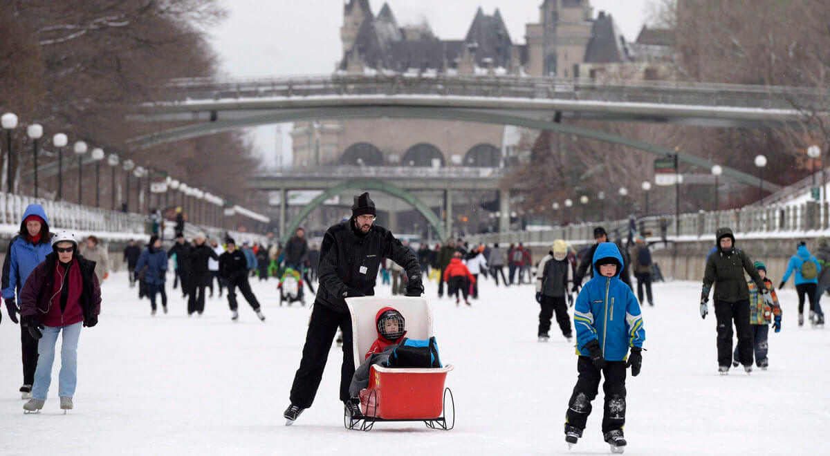 The Chateau Laurier is seen behind skaters on the the Rideau Canal Skateway on the first weekend of the National Capital Commission's Winterlude Festival in Ottawa, Saturday, Jan. 30, 2016. THE CANADIAN PRESS/Justin Tang