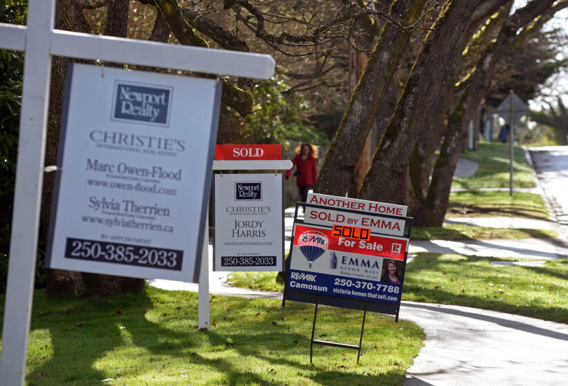 Sold stickers on real estate signs along Beach Drive in the greater Victoria Municipality of Oak Bay, Victoria, BC. (Don Denton/CP)