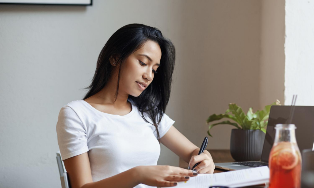 Young woman studying her critical illness insurance policy