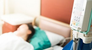 patient lying in hospital bed - critical illness insurance
