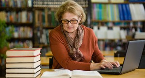 mature student studying in library