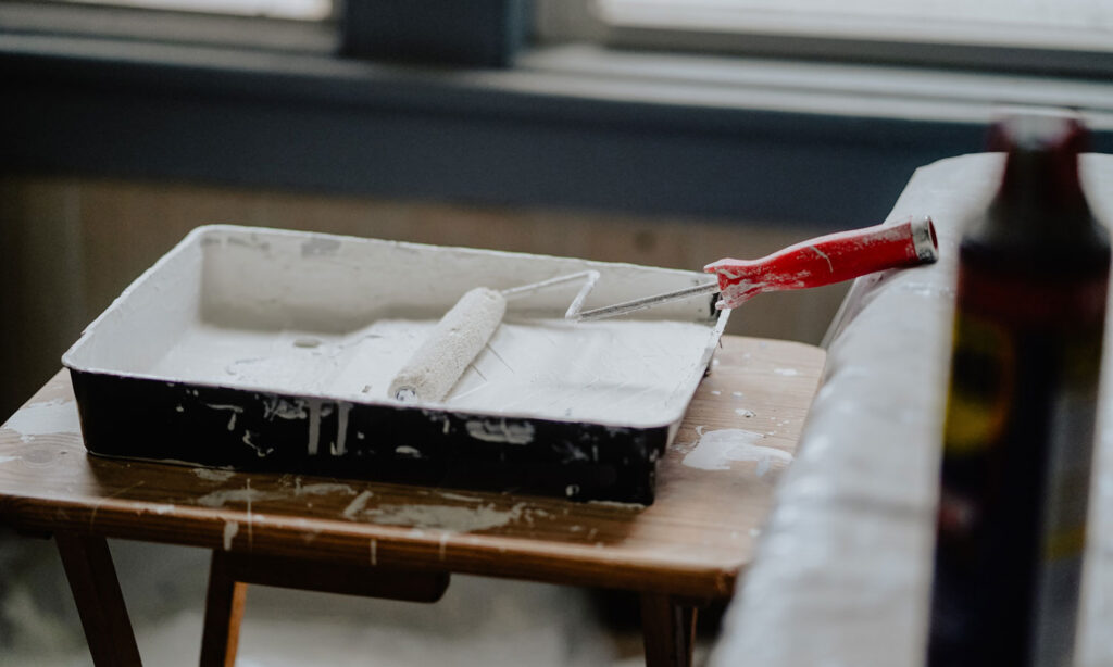 A paint tray of fresh paint for the walls.