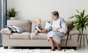 a grandmother and grandchild on a couch