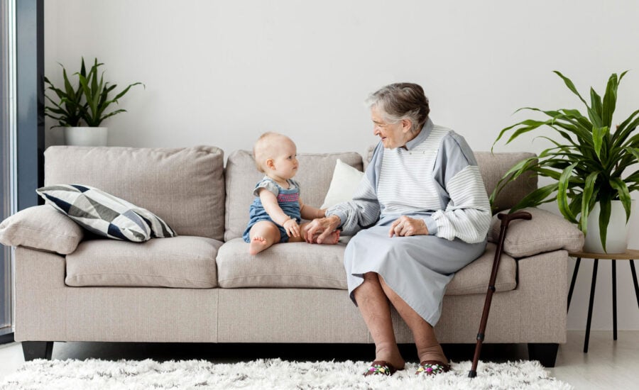 a grandmother and grandchild on a couch