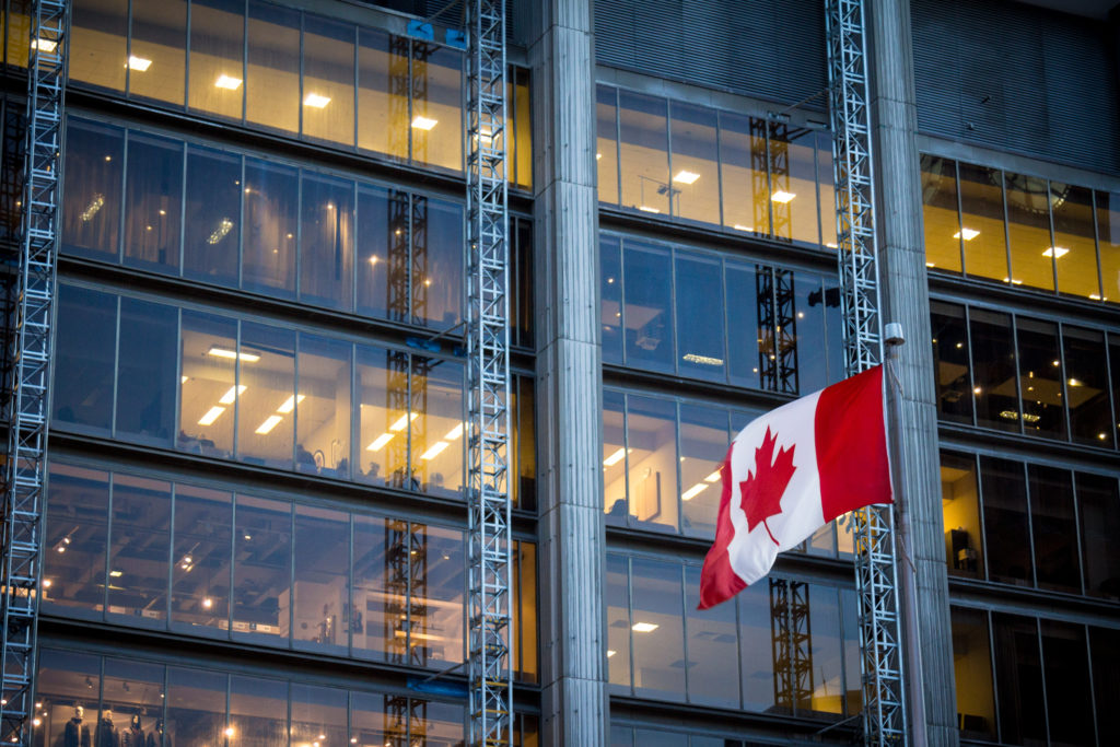 Canadian flag in front of a business building in Toronto, Ontario, Canada