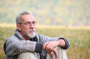 man sitting in field