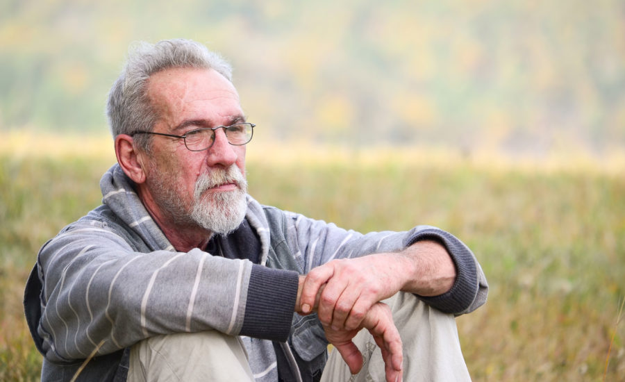 man sitting in field