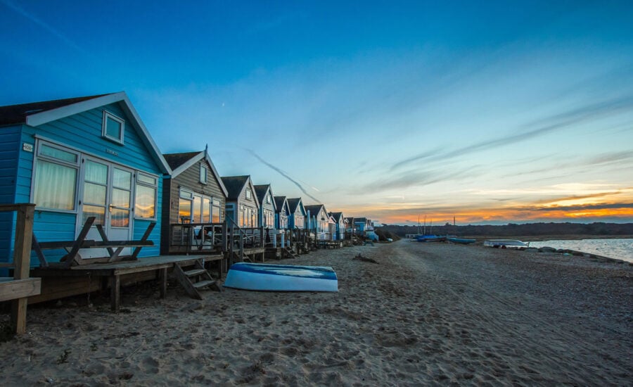 A beach front view of a row of cottages