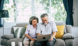 Senior couple talking with laptop computer