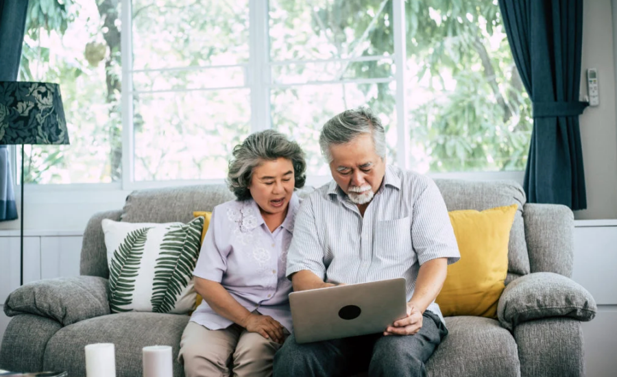 Senior couple talking with laptop computer