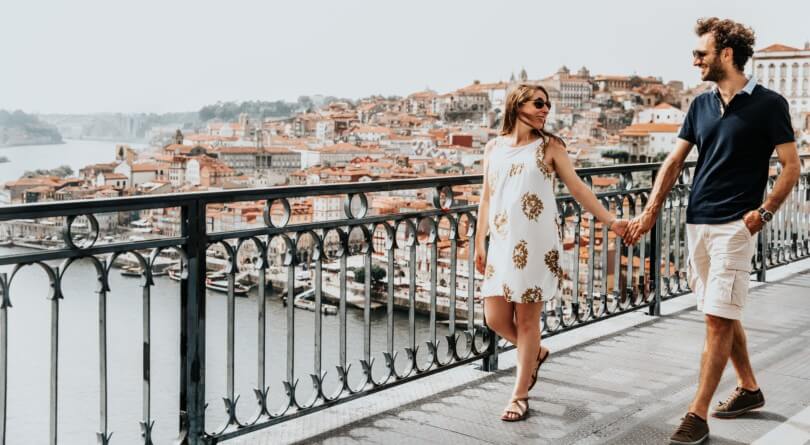 a couple walking along a bridge