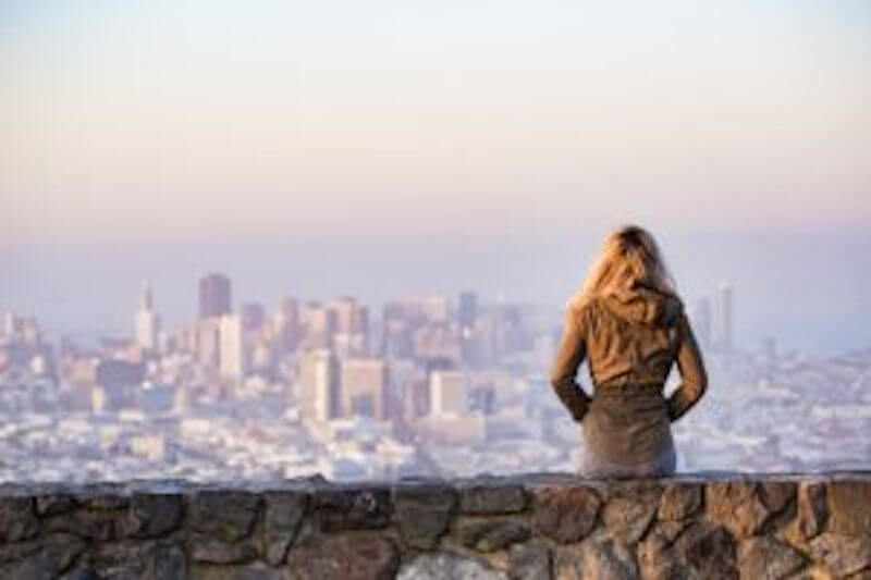 a woman sitting on a wall