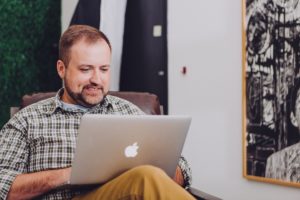 Man typing on his laptop