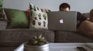 a man on a couch with a laptop