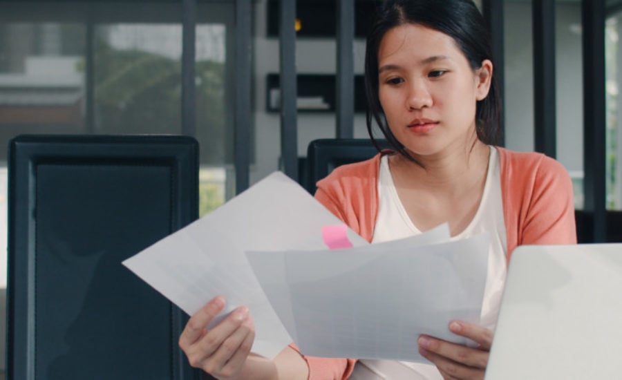 a woman looking over pages