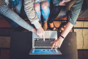 A young woman is applying for OSAP on her laptop