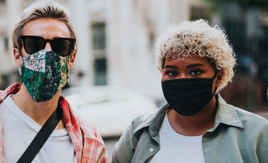 two young people wearing fabric face masks