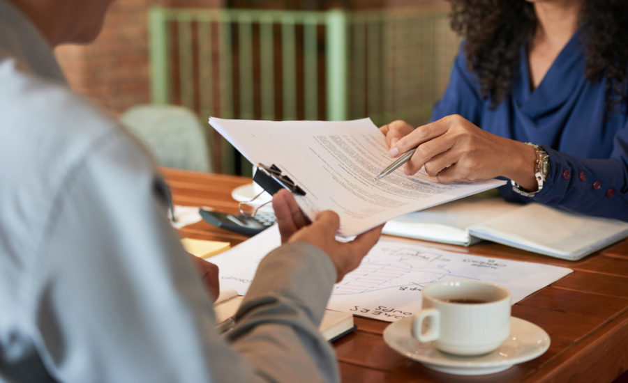 Man consulting with lawyer before signing contract