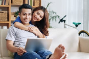 Smiling couple with laptop