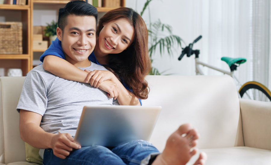 Smiling couple with laptop