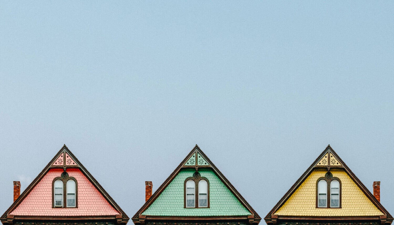 Three homes shown with pointed roofs