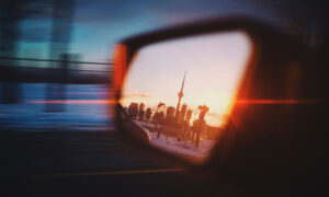 Review mirror showing the city scape of Toronto with the CN Tower at the peak