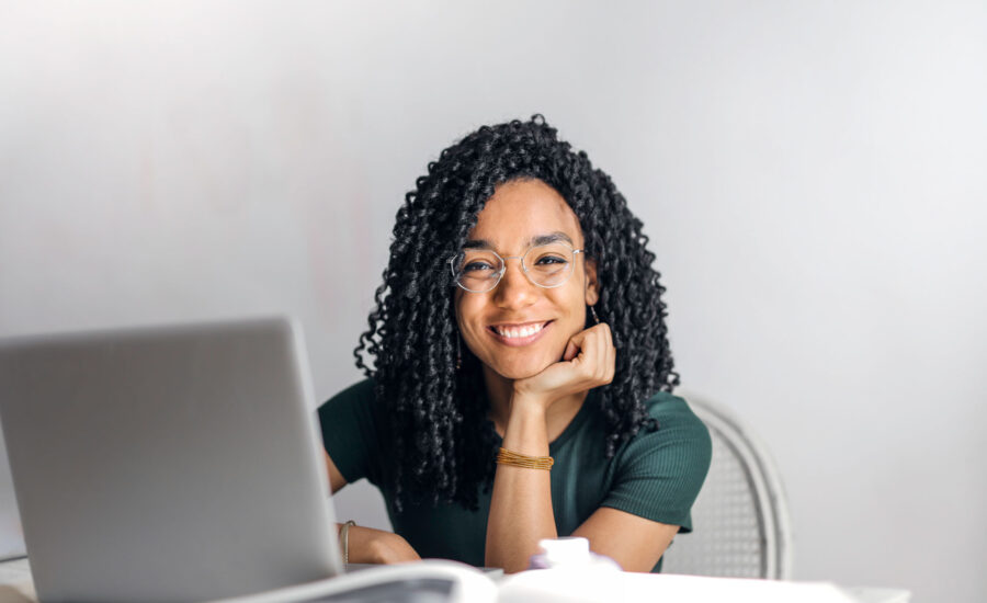 A woman happy smiling because she knows what she needs to do to apply for a credit card and get approved! Wahooo!
