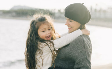 mom holding up her daughter