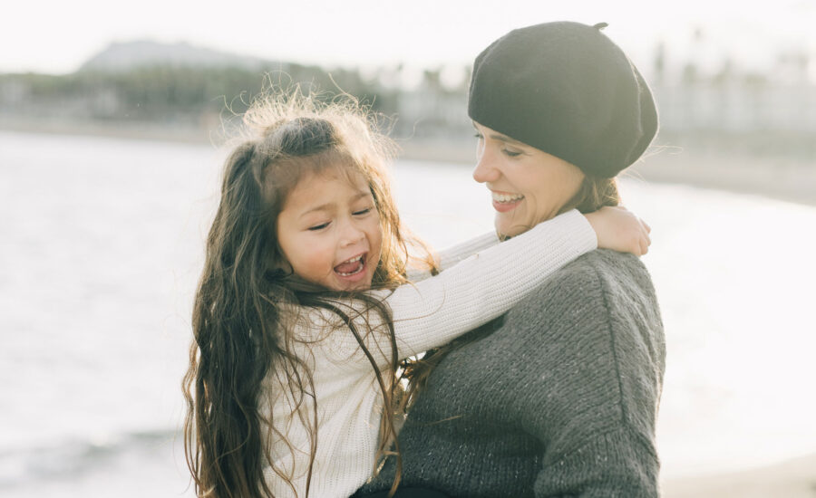 mom holding up her daughter