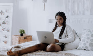 a woman shopping online wearing sweatshirt and shorts