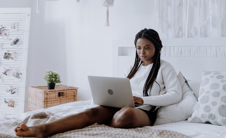 a woman shopping online wearing sweatshirt and shorts