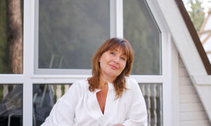 A woman in a blouse smiling