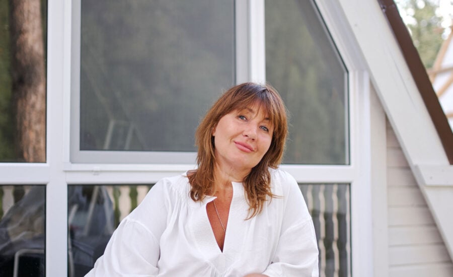 A woman in a blouse smiling