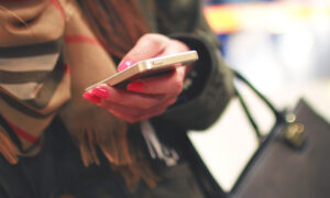 Woman holding a phone while shopping