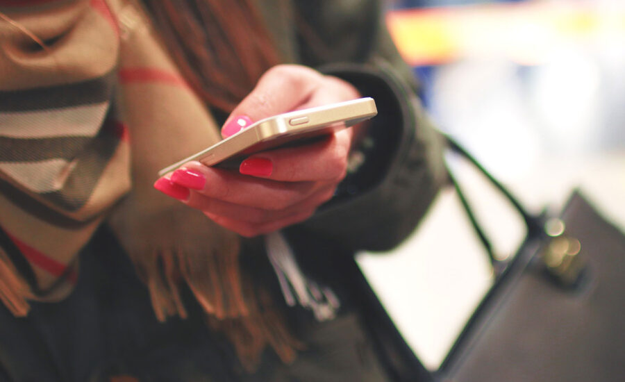 Woman holding a phone while shopping