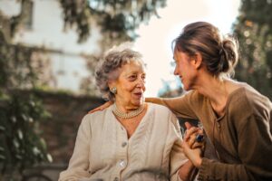 Senior woman sitting with adult daughter in a park