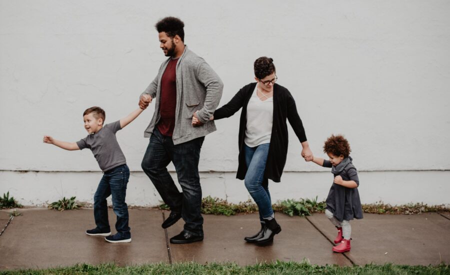 young family walking hand-in-hand