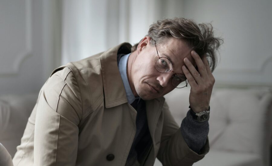 worried man wearing trenchcoat