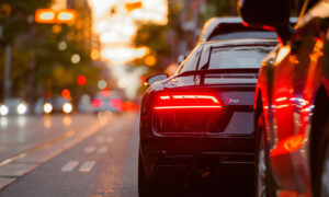 Two cars stopped at the side of the road on a busy downtown Toronto street.