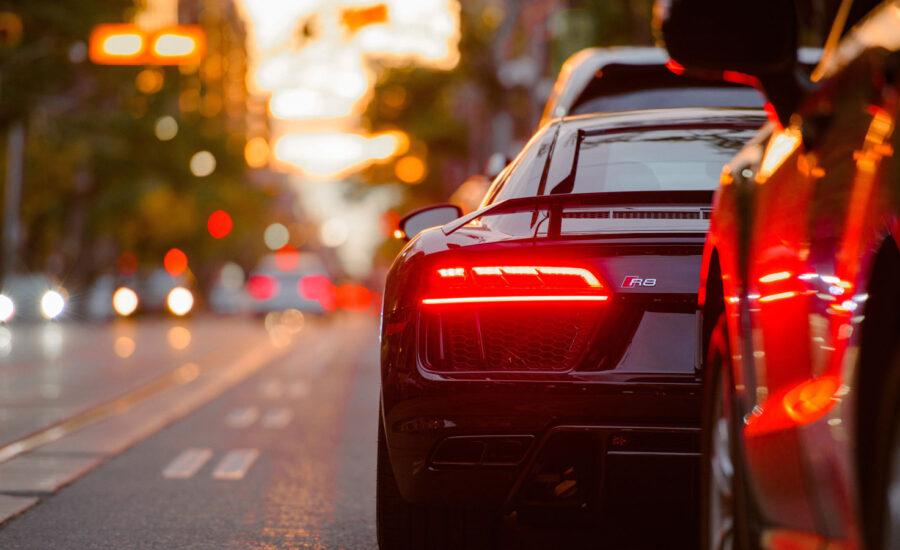 Two cars stopped at the side of the road on a busy downtown Toronto street.