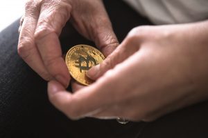 close-up of hands holding bitcoin