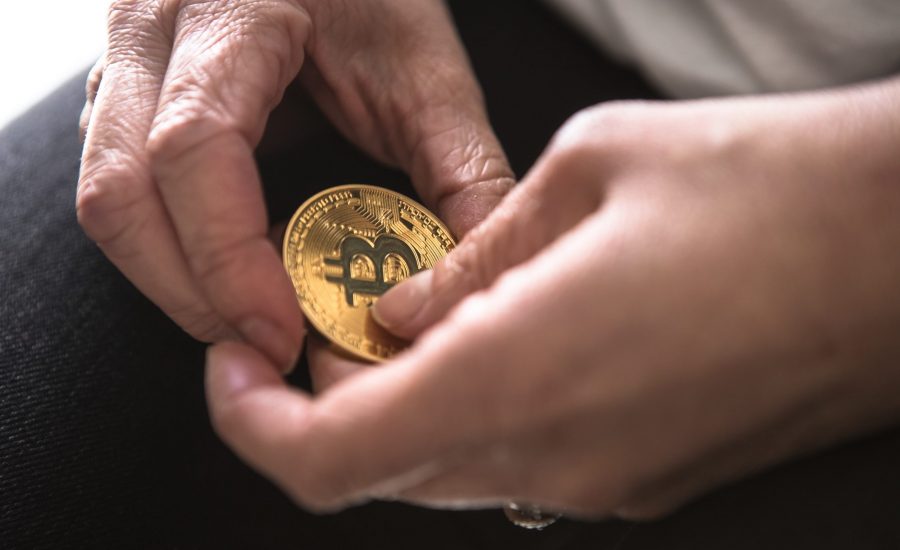 close-up of hands holding bitcoin