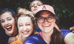 A group of friends taking a selfie to help celebrate each other.